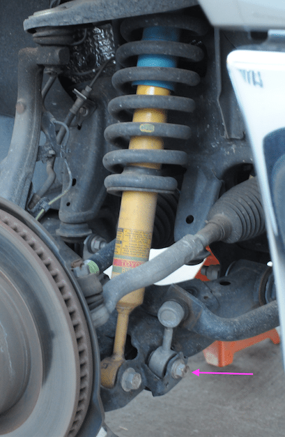 Remove the front sway bar end-link bolt from the lower control arm.