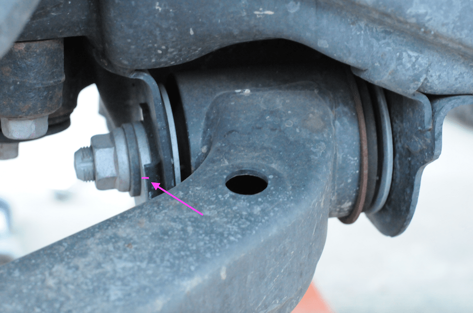 This is where you make your marks. With your marks made, loosen these two nuts/bolts, but do not remove them. This will allow you the extra movement required of the lower control arm to replace the shock/spring assembly.