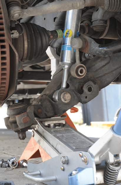 Once you get the upper shock rod up through the hole, make sure you get the bushing, washer, then nut on there and tighten it up. The rest of the installation follows the procedure in reverse order. 