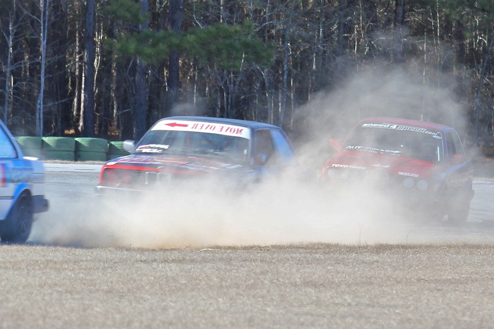 Rob Eskew slides off Carolina Motorsport Park’s Turn 14 and gets some dirt. Scott Gress and Craig Guthrie are looking to pounce.