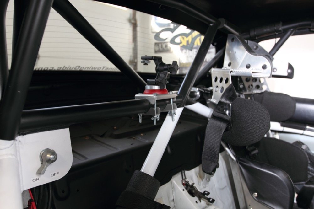 Painting the upper spans of the roll cage and the rear package tray flat black greatly reduces glare in the mirror, and helps the cage “disappear” when you’re driving. 