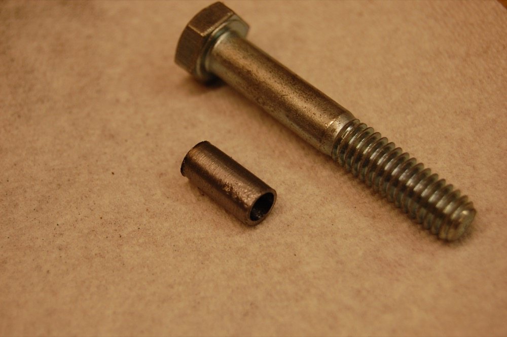 If your craftsmanship is particularly good, it is possible to do simple lathe machining operations with a drill motor and a file. The example in the photo is a cylindrical spacer that I needed on very short notice, so I made it by cutting, drilling, and filing a grade 2 bolt.