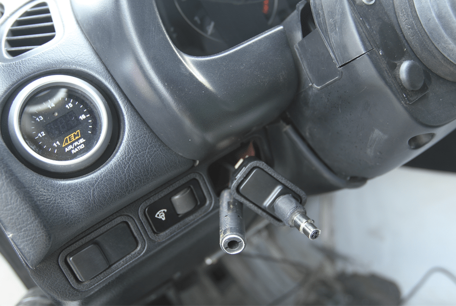 After we sorted the connector and the plate, we pushed the wires through the hole and routed them behind the dash.