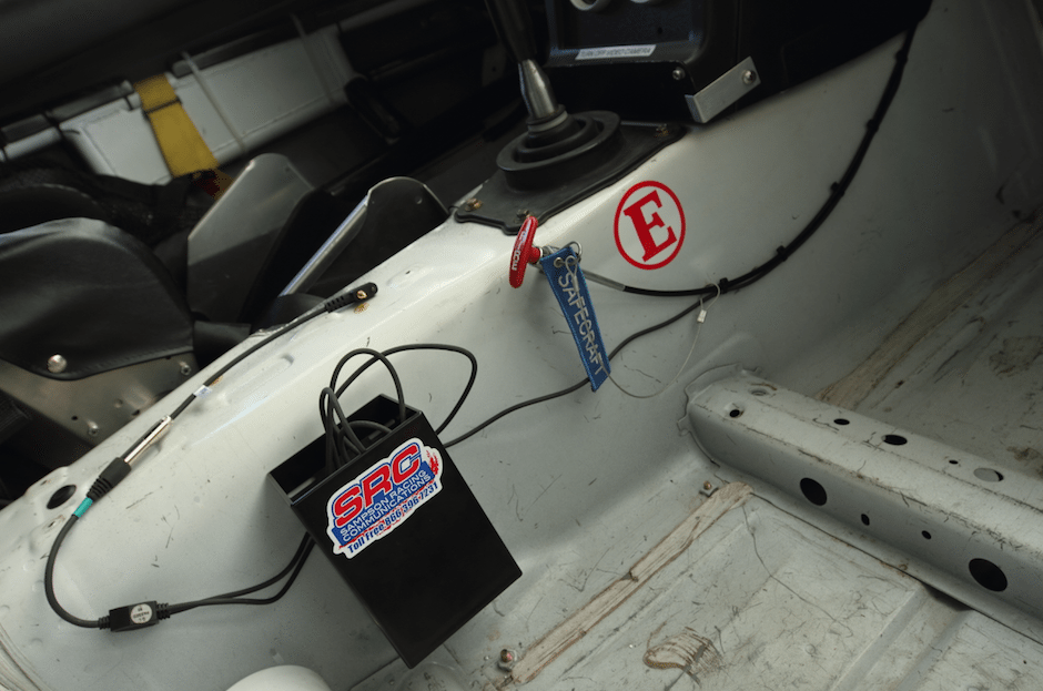 The radio mounting box comes with clamps to mount it to a roll cage, but there was nowhere to mount it on the cage where the driver could reach it, or where it wouldn’t be in harm’s way in the event of a collision. So we through-bolted it to the transmission tunnel.