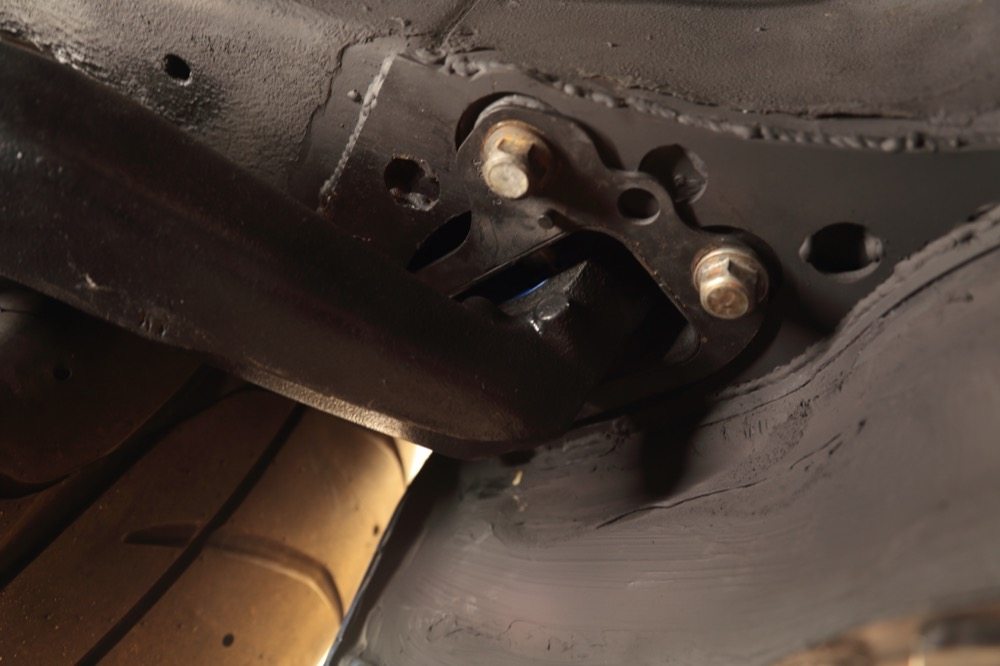 The front pickup point for the lower control arm is strengthened with a reinforcement plated welded to the chassis. This is a critical point because it’s where you adjust the toe settings.