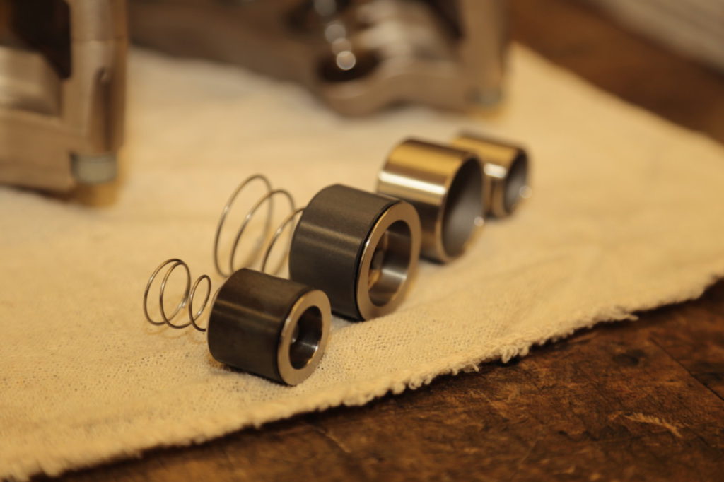 Because the Mini will be use for Time Trials and racing, the calipers will be fitted with special pistons. They have an additional insert, which helps prevent heat transfer from the pad through the piston to the fluid. Note the standard pistons in the background. 