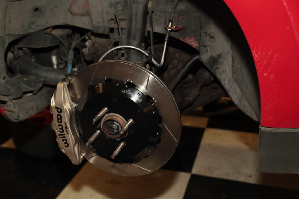 With everything installed on driver side, repeat the process on the passenger side, bleed the system and you’re done. It’s worth noting that the wheels Orozco had on his car required spacers to clear the calipers. 